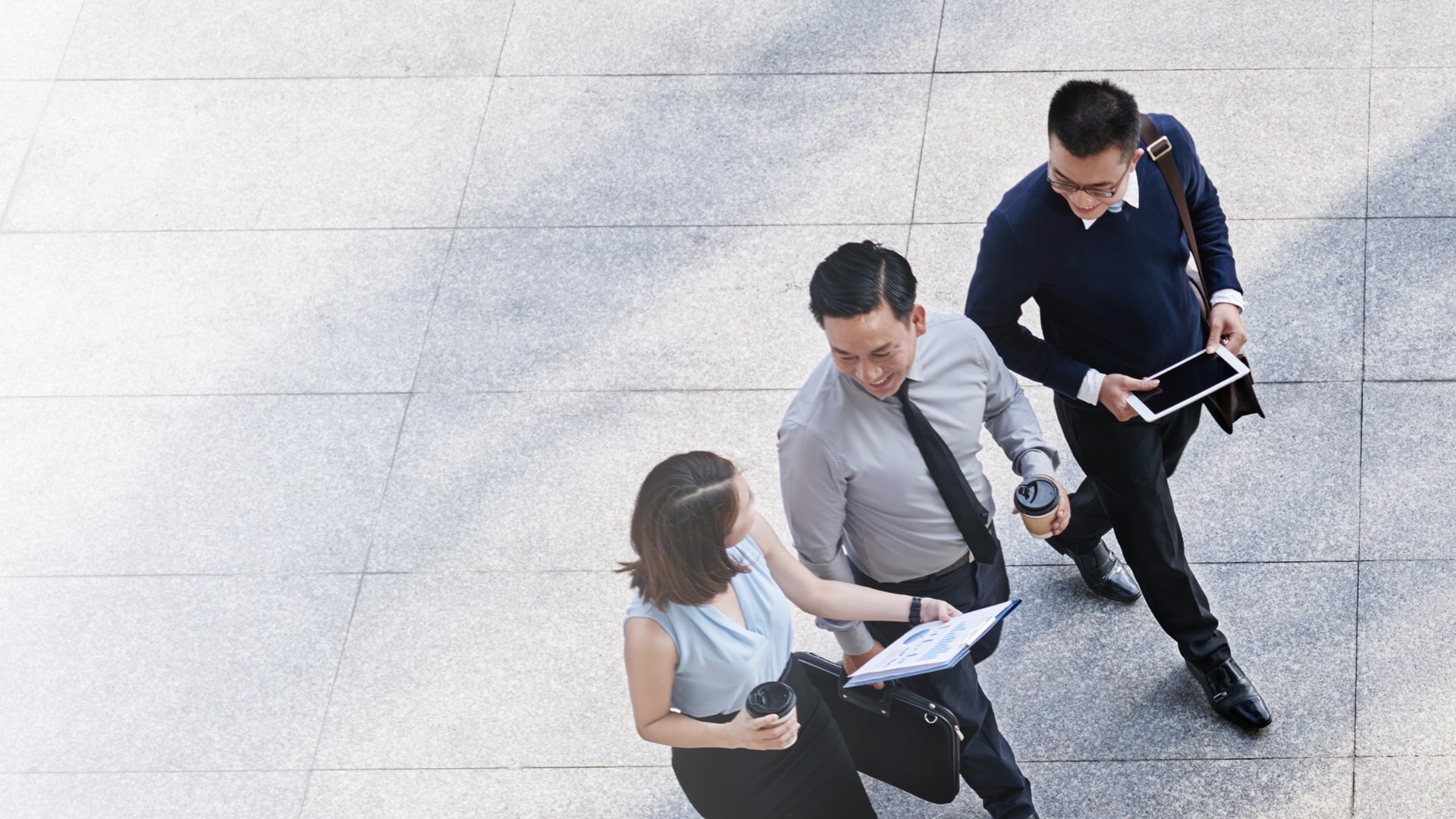 happy business people discussing while walking